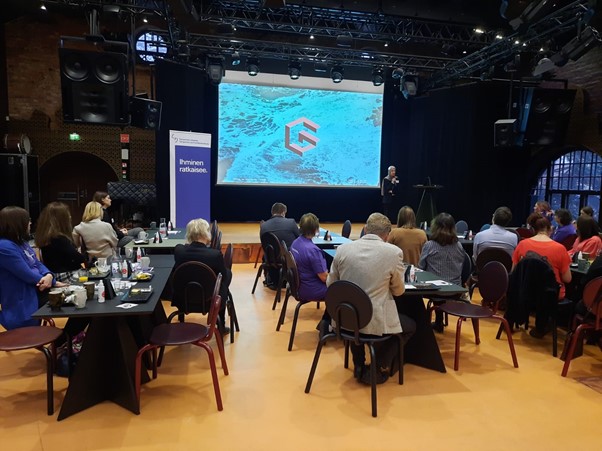 People looking at the screen at the Growth Through Internationalisation event at G Livelab.