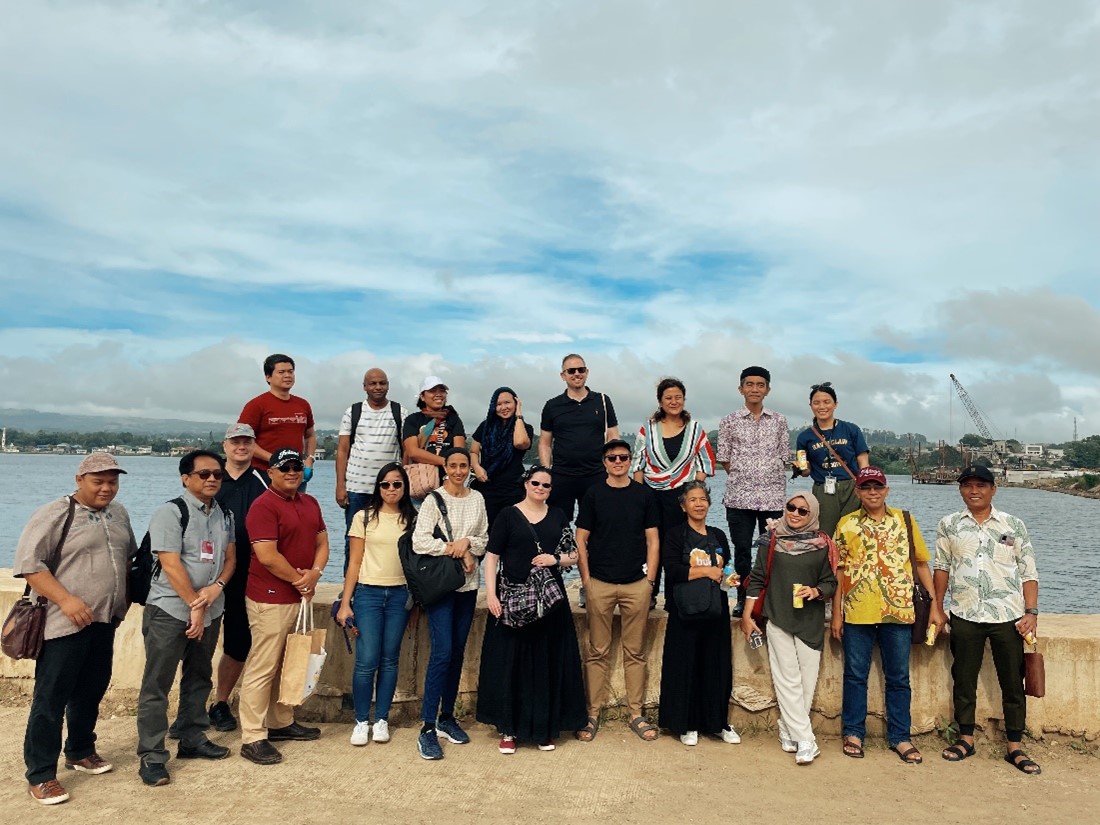People standing outside on a beach.