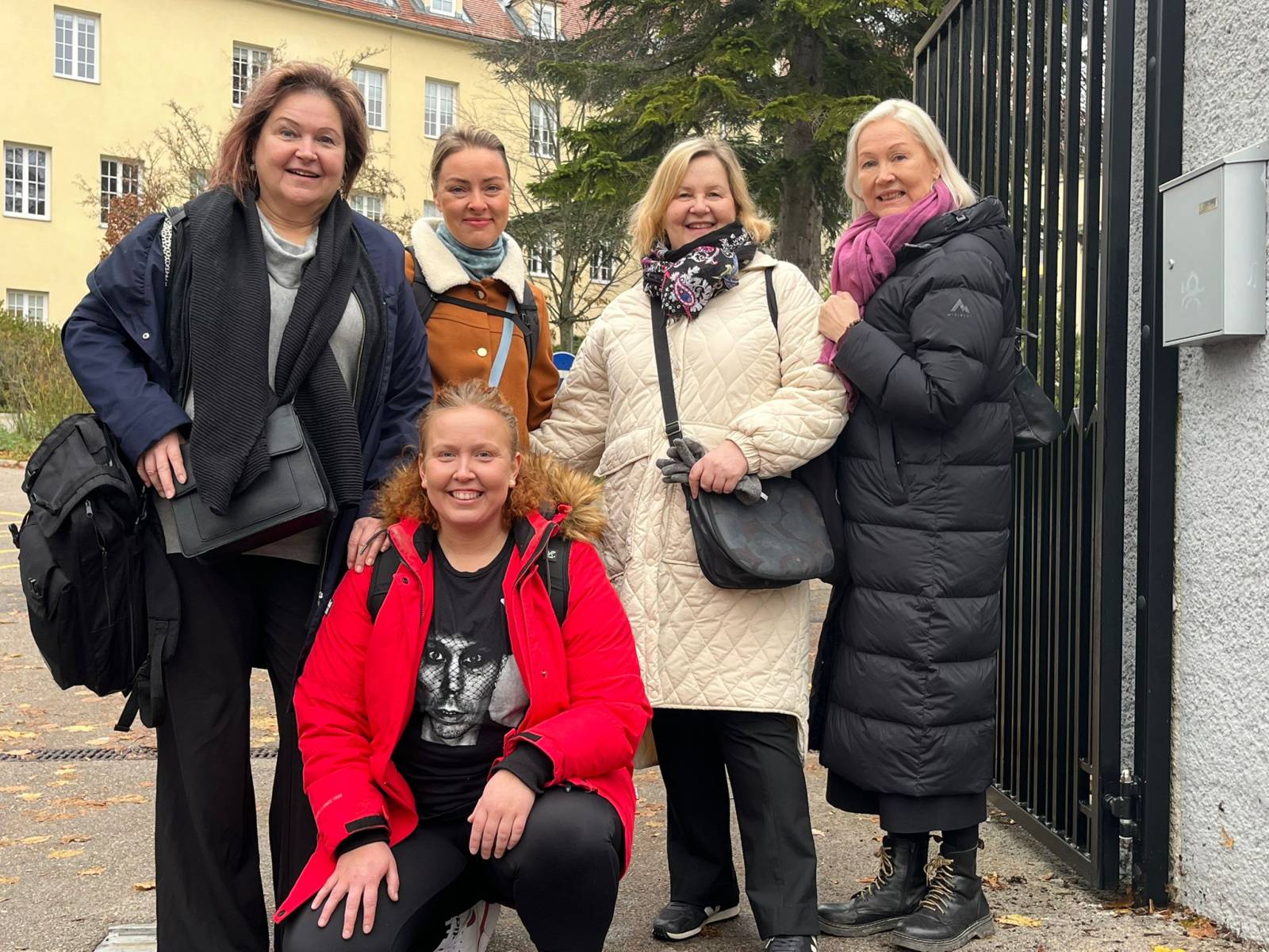 Five people smiling outside.