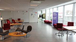 Lukion aulatila, jossa pöytiä ja tuoleja