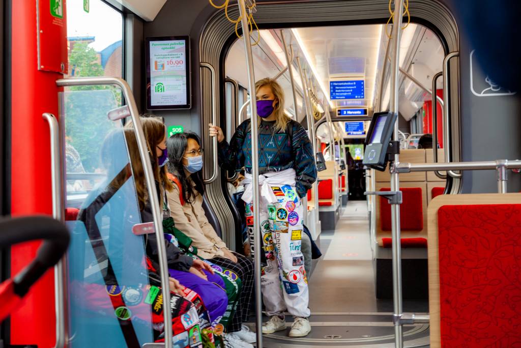Three students riding a tram