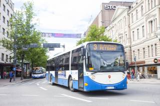 Blue and white Nysse bus driving on the street in Tampere
