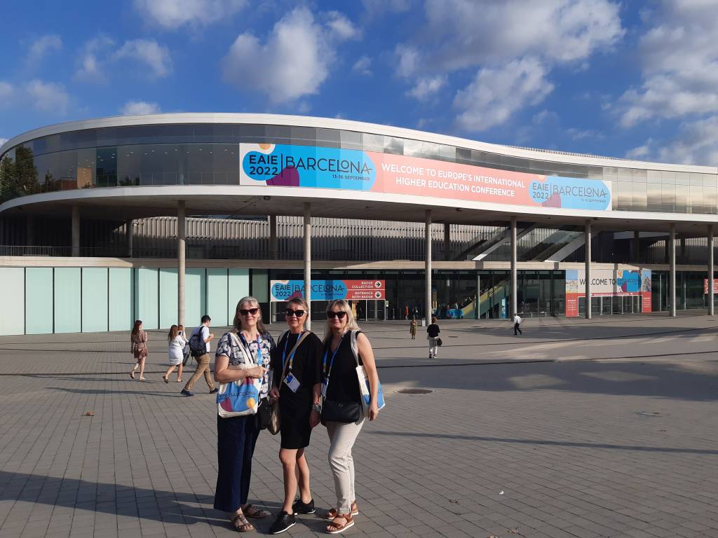 Tarja Kalliomäki-Linnas, Anne-Maria Mäkelä and Kirsi Jokipakka in front of the huge FIRA conference venue.