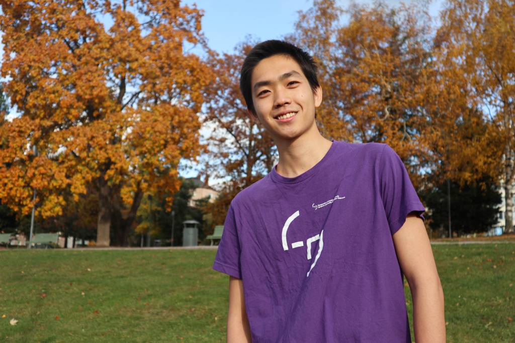 Young man standing in park.