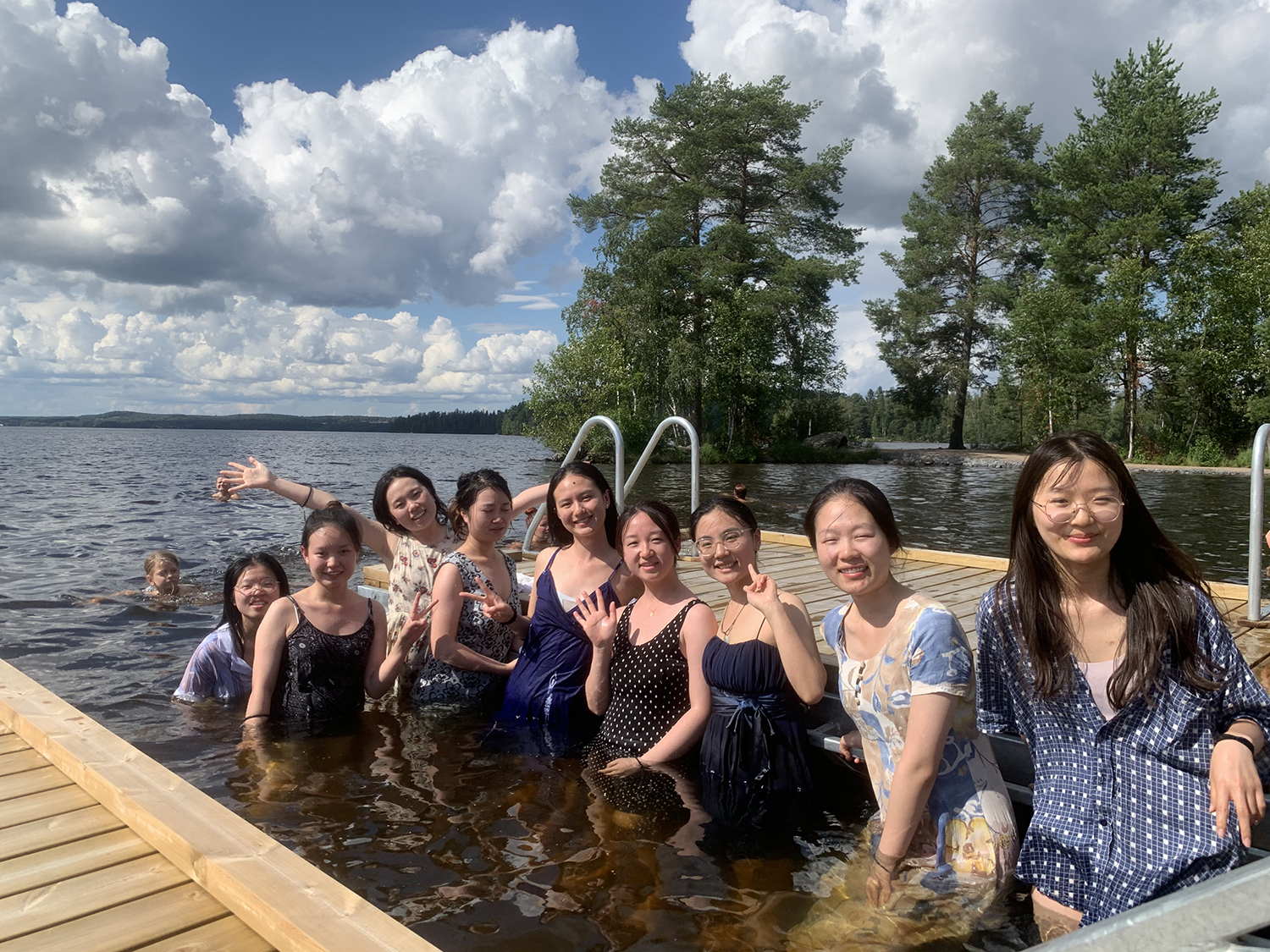 Chinese students standing in a lake.