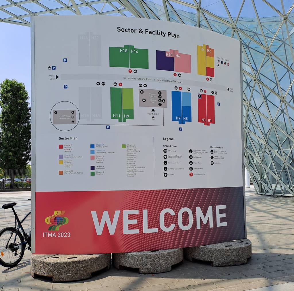 Welcome to ITMA 2023 sign with sector and facility plan on it.