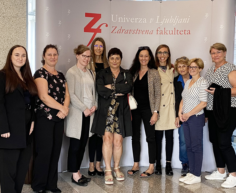 Ten people standing next to each other.