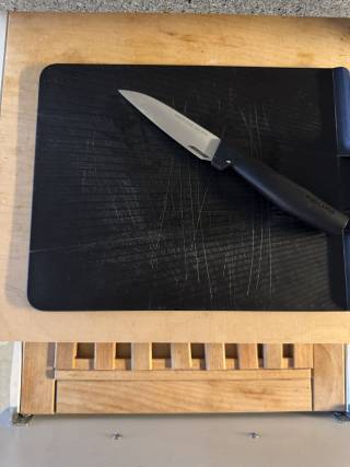 Chopping board with paring knife