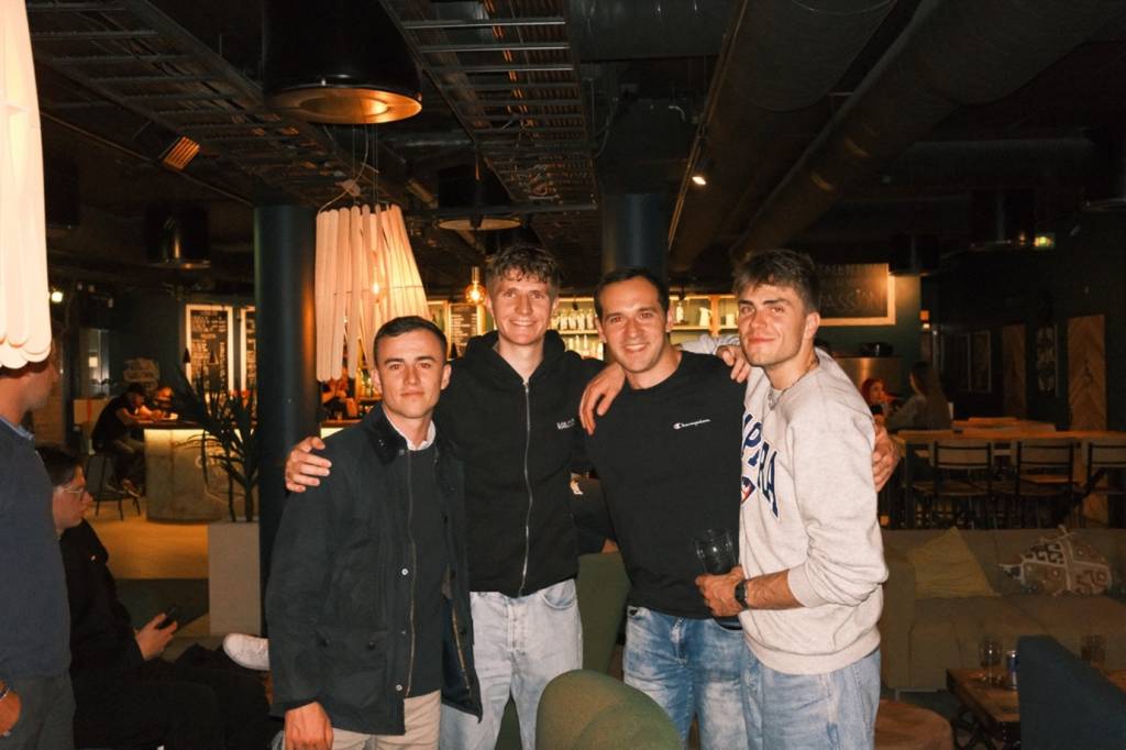 Four men standing and smiling