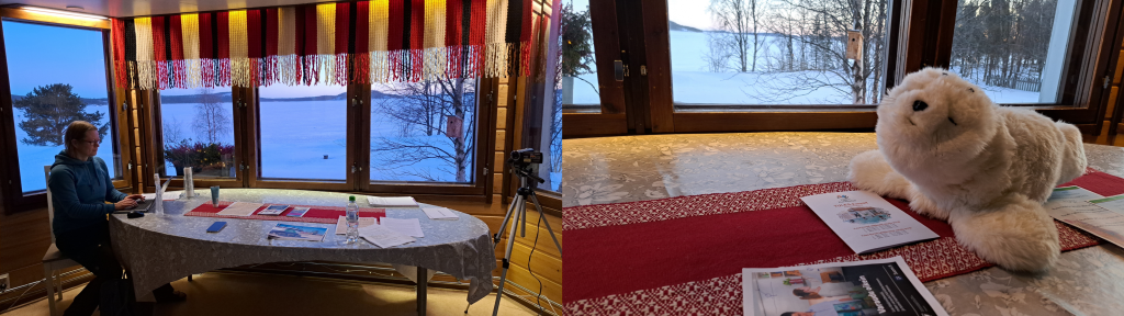 A person making notes on computer. A Paro seal robot on table.