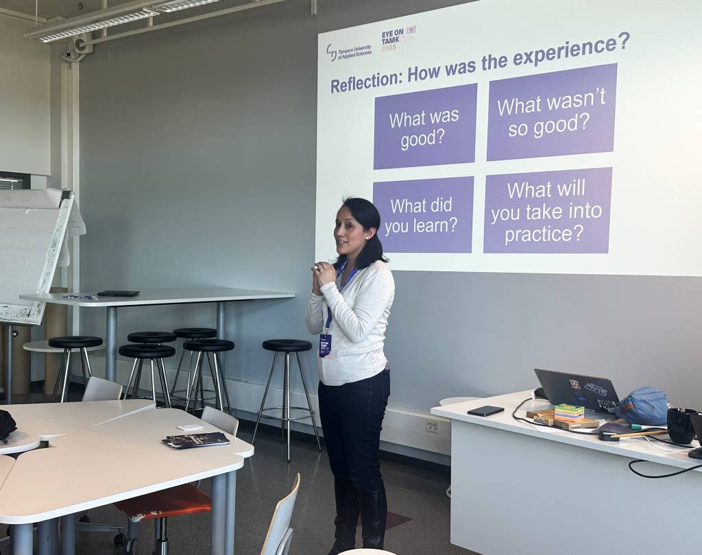 A woman standing in front of the screen