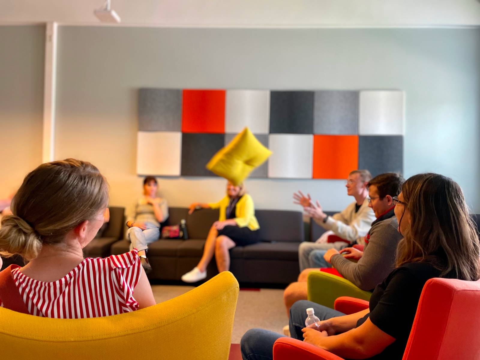 People throwing a pillow in the room.