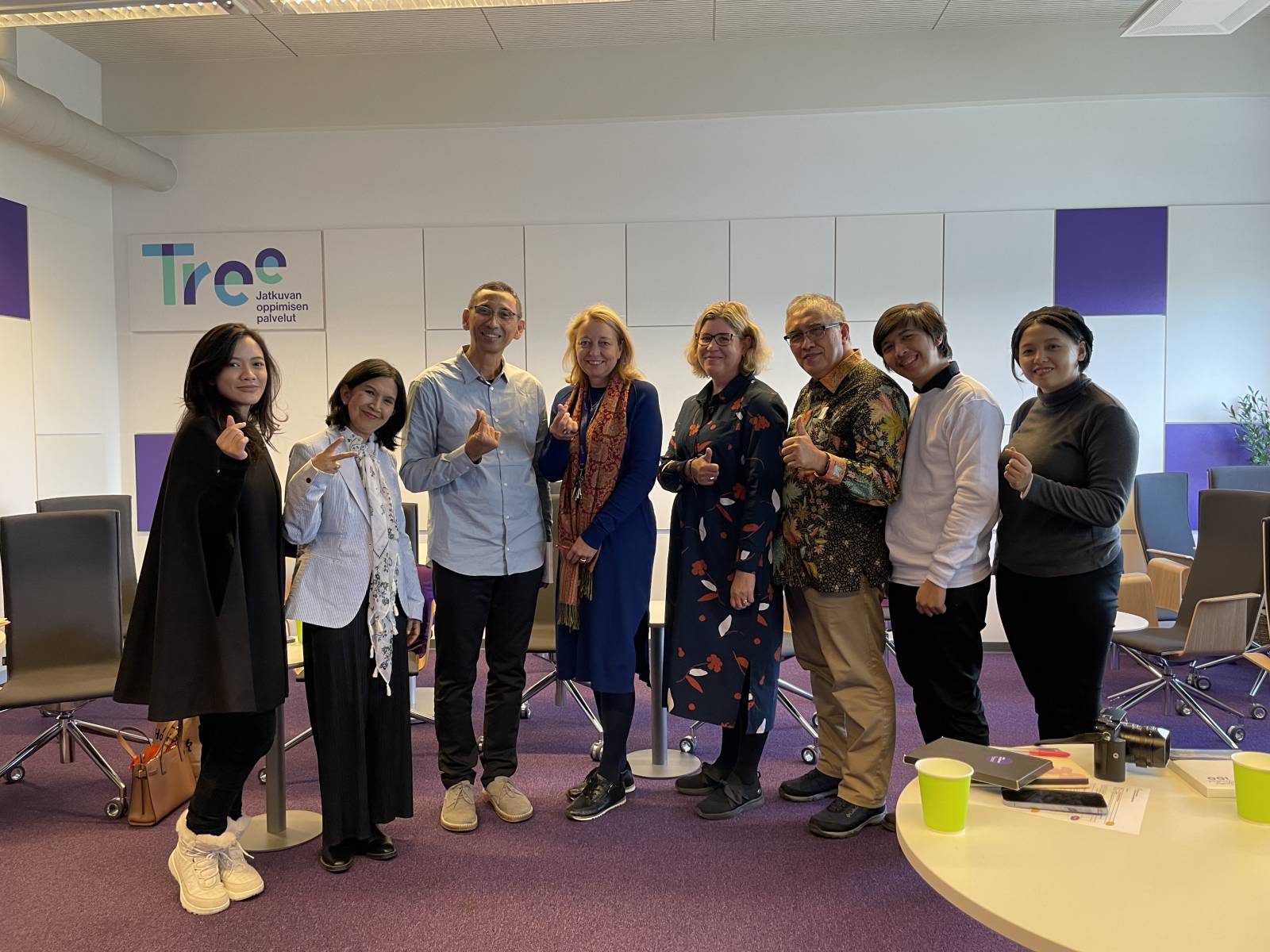 Eight people standing next to each other and smiling.