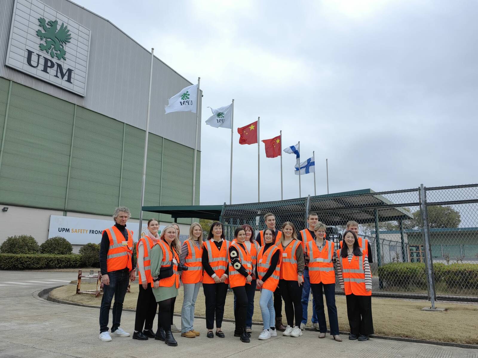 People standing in a group wearing safety vests.