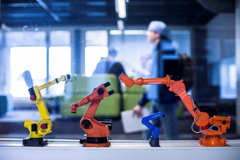 Four tiny robotic figures next to each other.