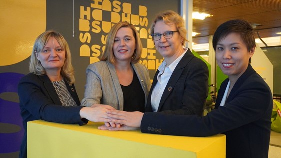 people posing holding hands