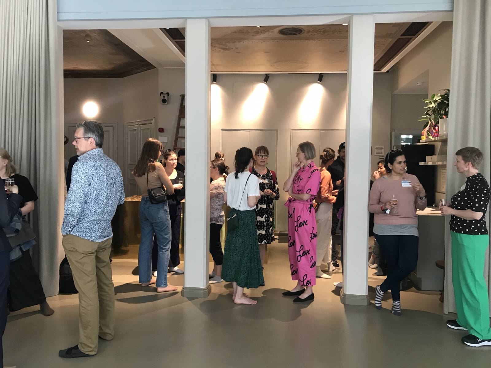 People standing and talking to each other in a room.