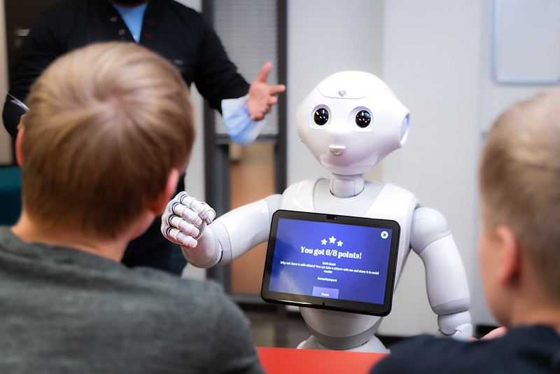 Pepper robot with two students