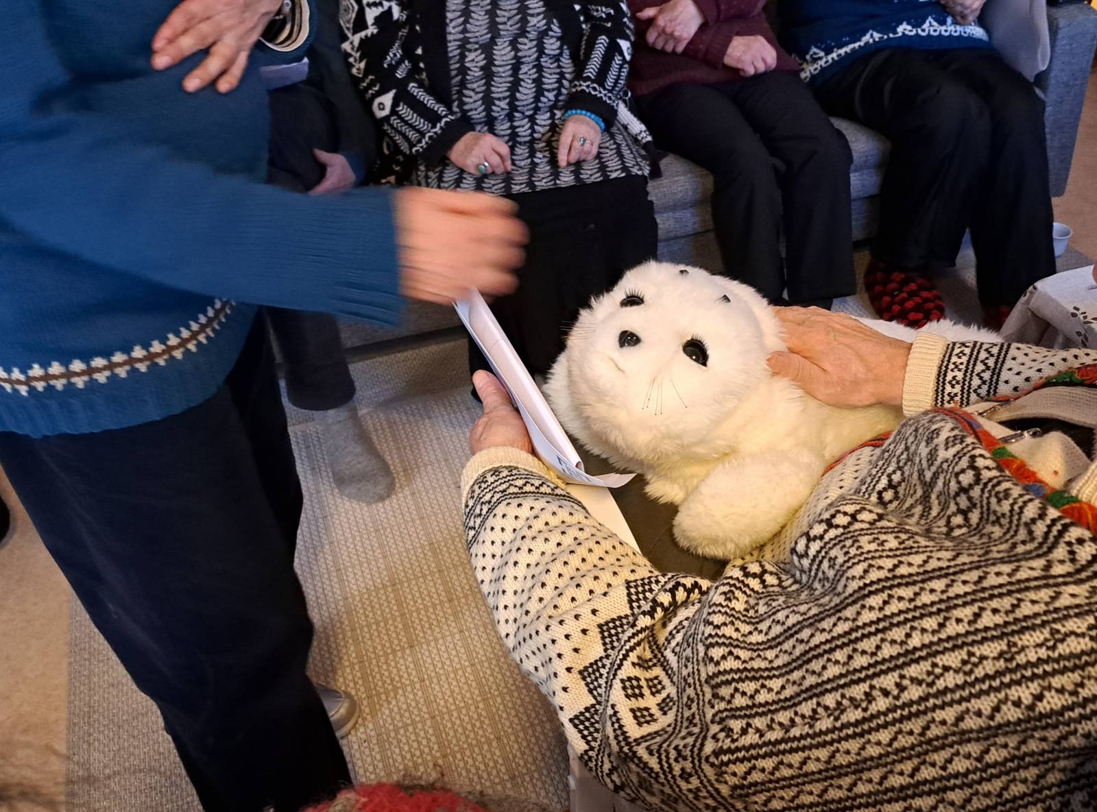 Paro seal robot in the lap.