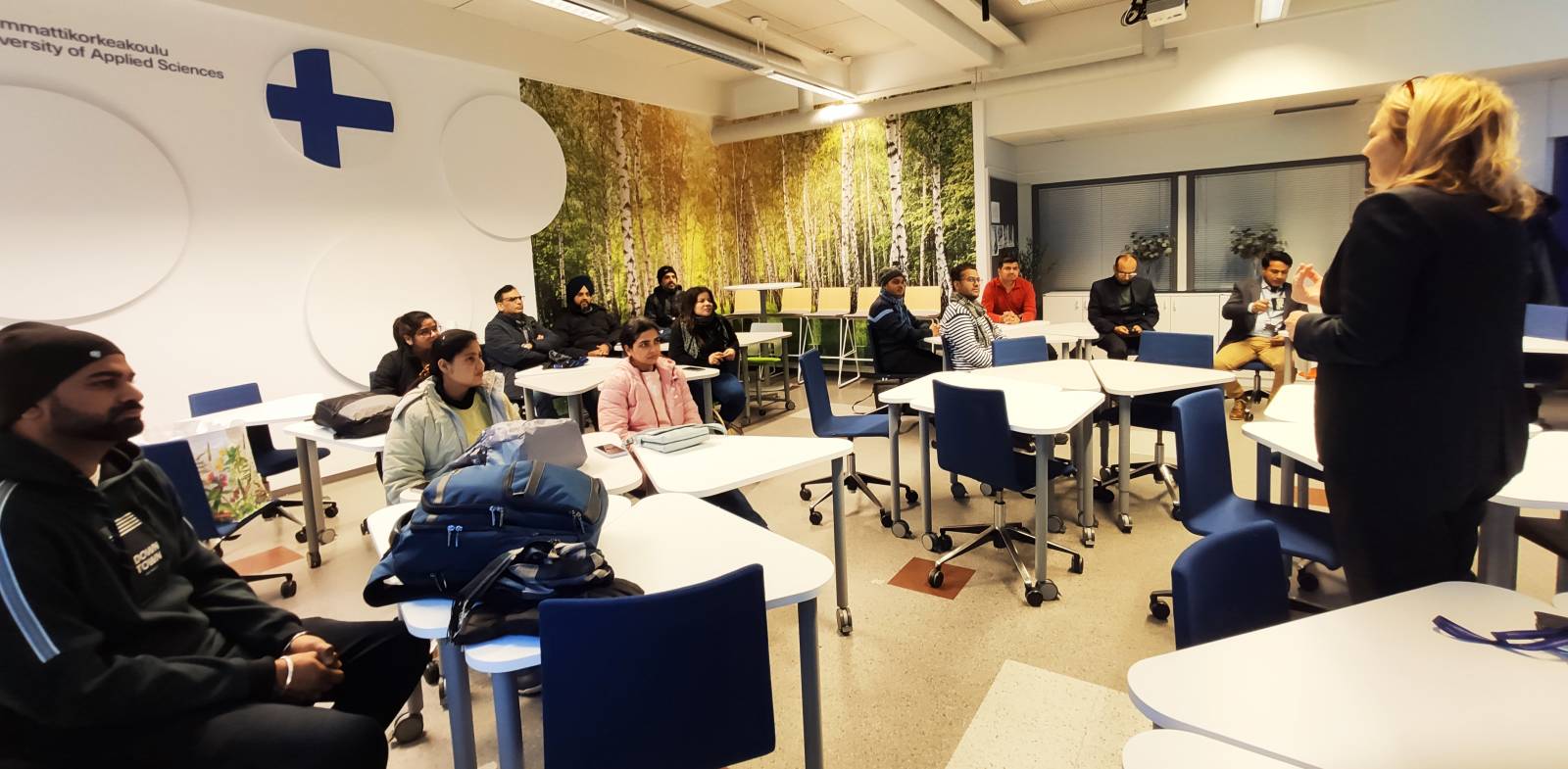 Carita Prokki is welcoming the new students in a classroom.