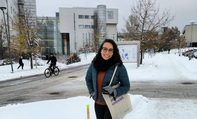 Bianca standing in the snowy yard of City centre campus.