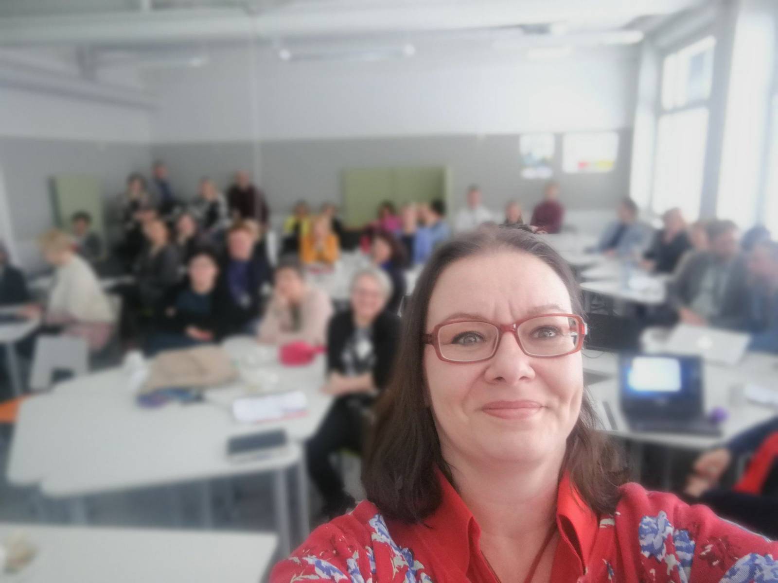 Ursula in front of classroom, teaching students