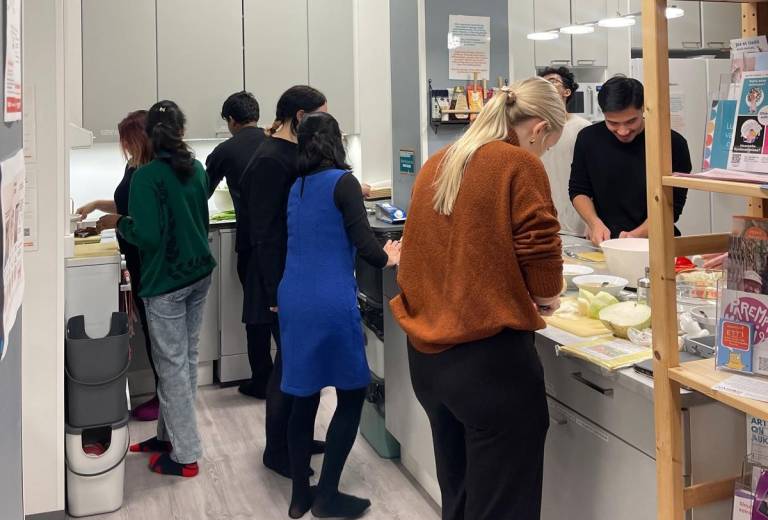 Students preparing food in the kitchen.
