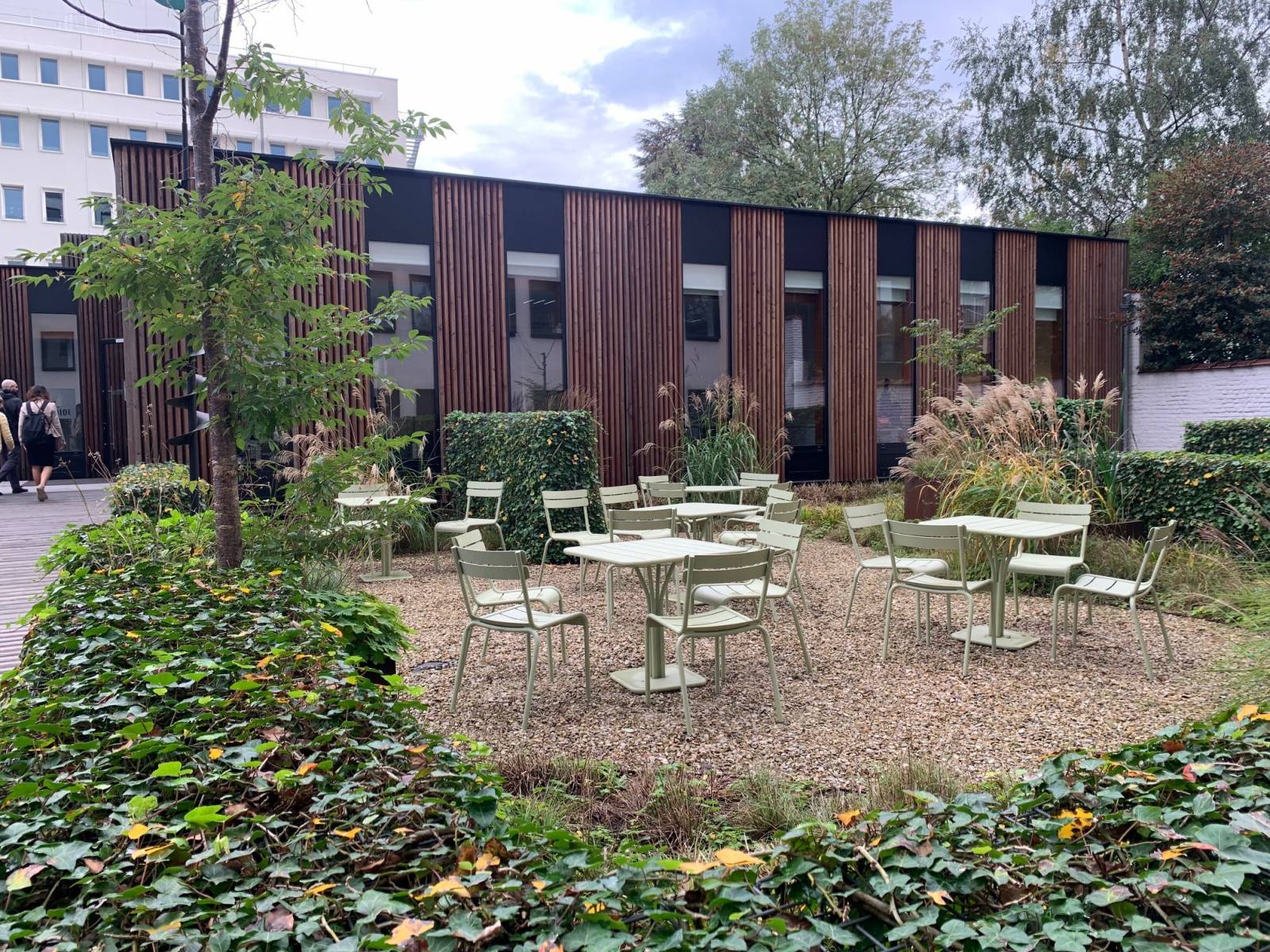 Tyhjiä pöytiä ja tuoleja pihalla rakennuksen edessä Brysselissä.