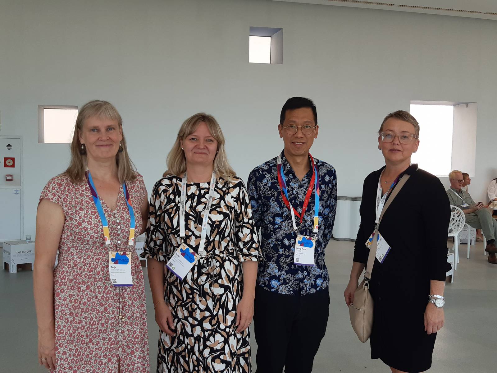 Four people standing next to each other and smiling.