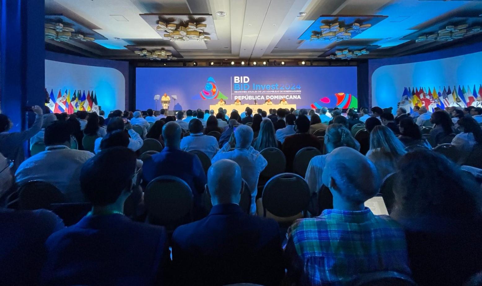 Audience looking at the stage in dim lightning.