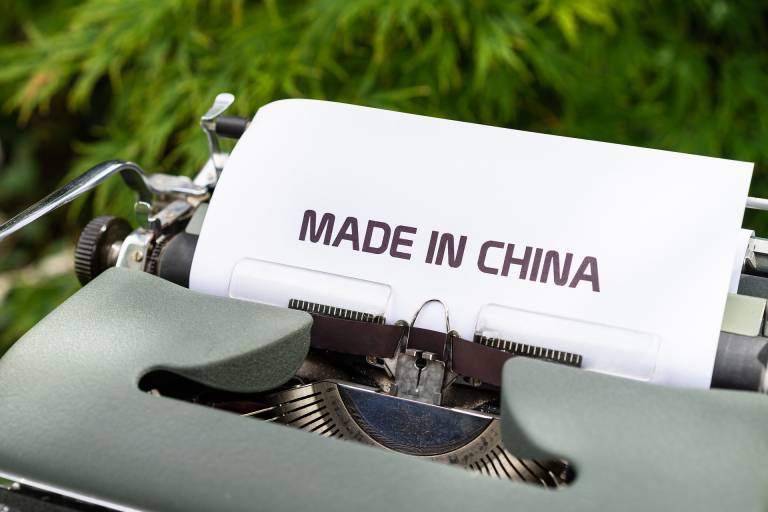 Type machine with a paper on it that says "Made in China".