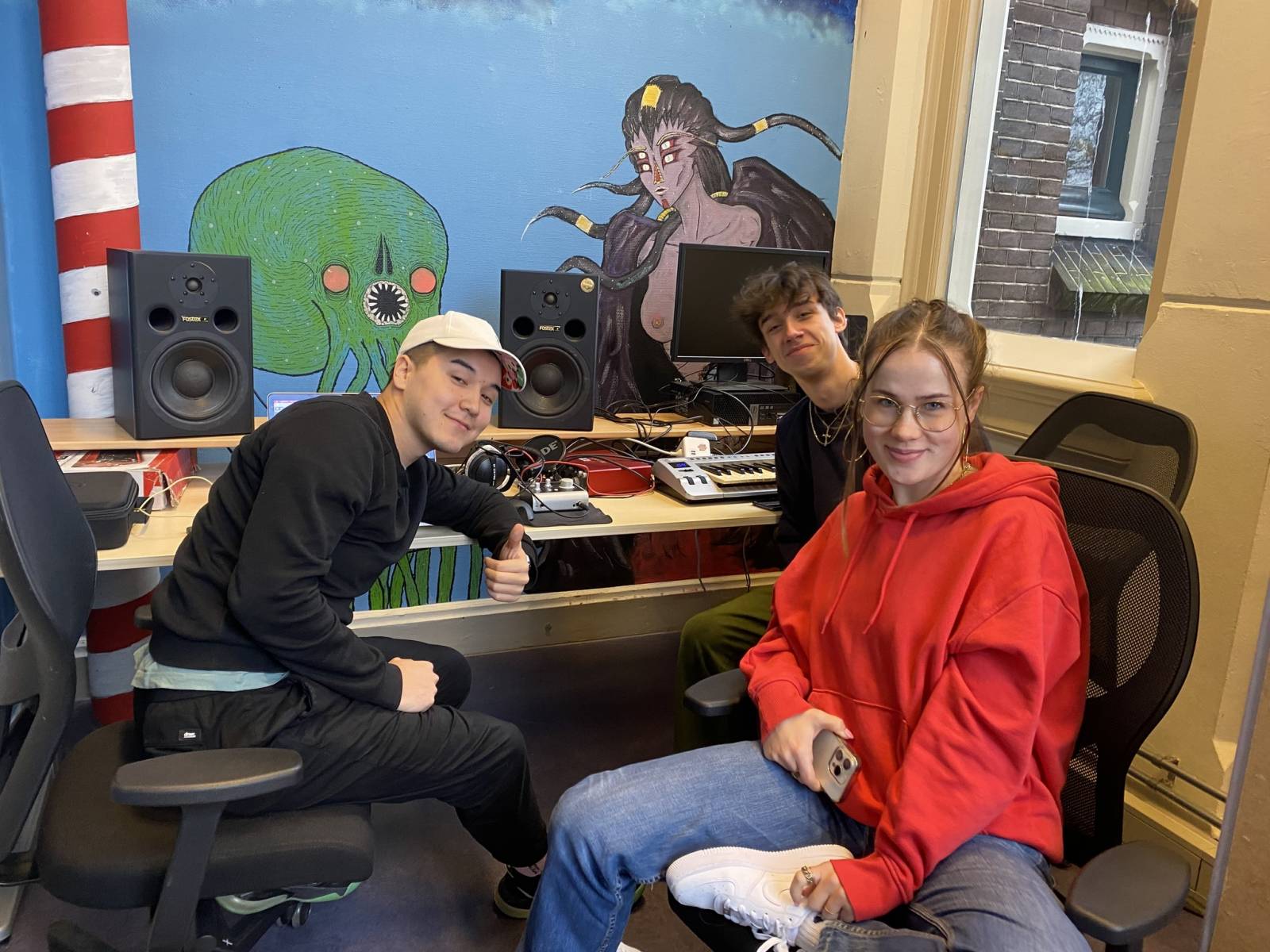 Three people in a music studio.