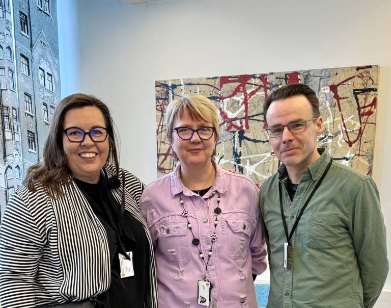 Johanna, Marjaana ja Mikko hymyilevät.