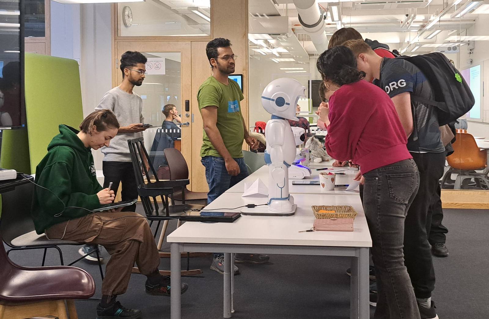 Students conducting activities around QTRobot.