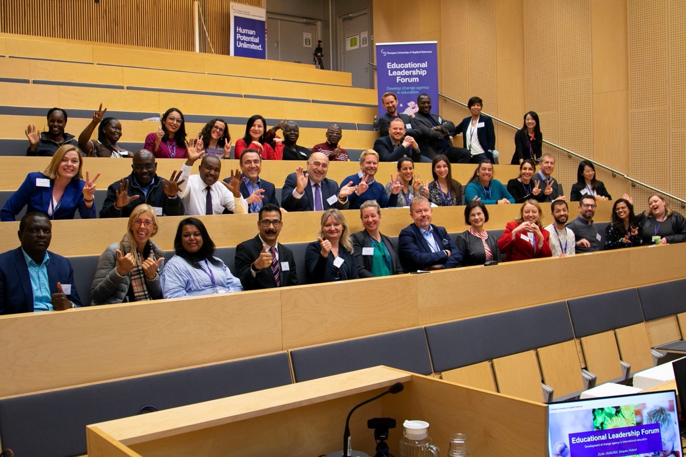 People sitting and smiling in a classroom.