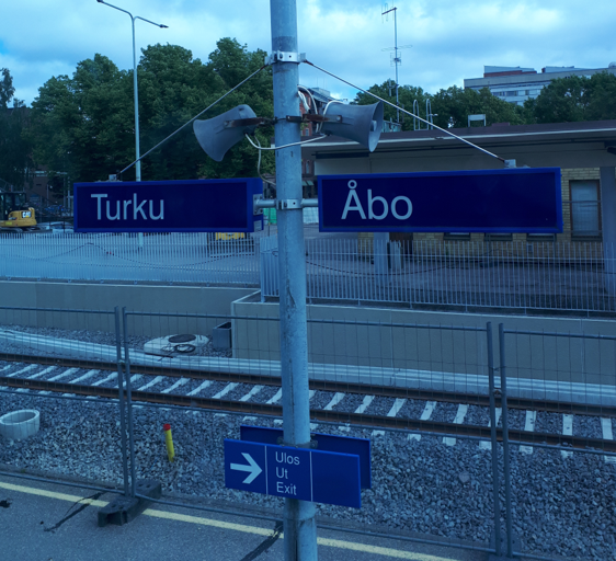 Two signs at a trainstation show the two different names of Turku/Åbo