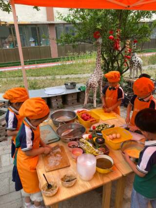 Chinese children cooking around the table.