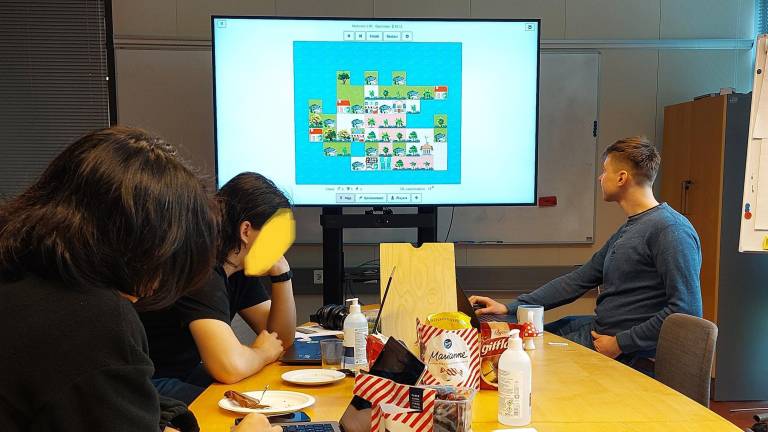People around the table playing gamified methos in research