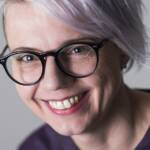 Kasvokuva hymyilevästä silmälasipäisestä henkilöstä