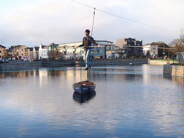 A tightrope walker crossing the River Corrib in Galway.